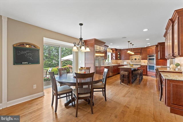 25 Ginnie Ln, West Windsor, NJ 08550 - dining room featuring light wood-style floors, a chandelier, baseboards, and recessed lighting