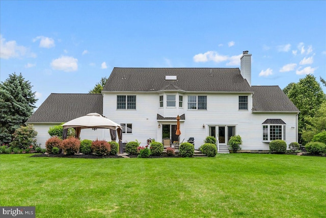 25 Ginnie Ln, West Windsor, NJ 08550 - back of property with a gazebo, a lawn, a chimney, and a patio