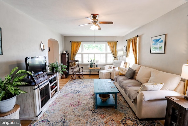 72 Springs Ave, Gettysburg, PA 17325 - living room with arched walkways, a ceiling fan, wood finished floors, and a baseboard heating unit