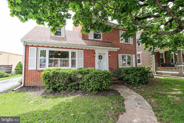 72 Springs Ave, Gettysburg, PA 17325 - view of front of property with brick siding, a front lawn, and roof with shingles