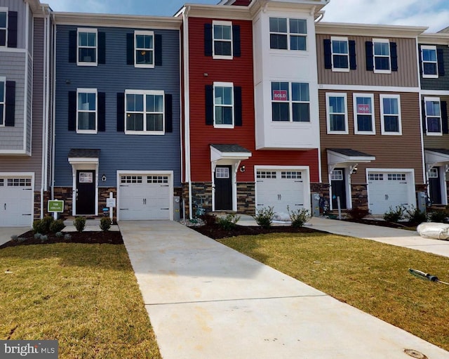 11274 Davisar Rd, White Marsh, MD 21162 - townhome / multi-family property with concrete driveway, an attached garage, a front lawn, and stone siding