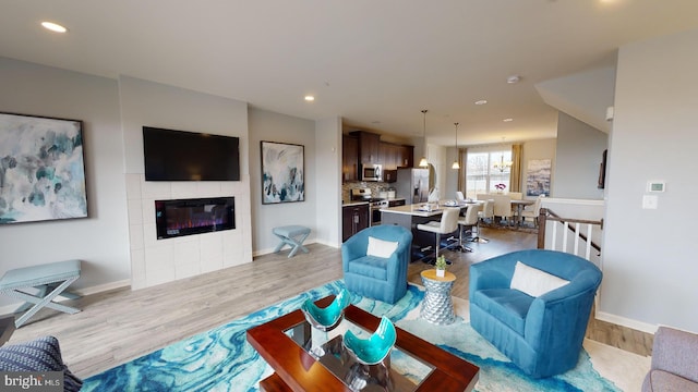 11274 Davisar Rd, White Marsh, MD 21162 - living room with wood finished floors, baseboards, a tile fireplace, and recessed lighting