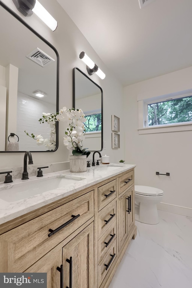 2655 Gap Newport Pike, West Grove, PA 19390 - bathroom featuring marble look tile flooring, double vanity, and toilet