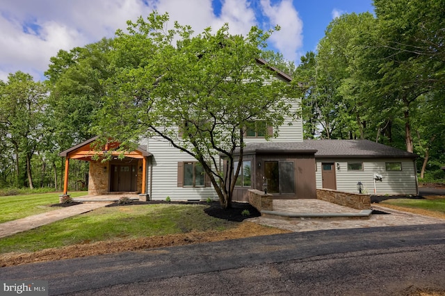 2655 Gap Newport Pike, West Grove, PA 19390 - view of front of house with a front yard, stone siding, and roof with shingles