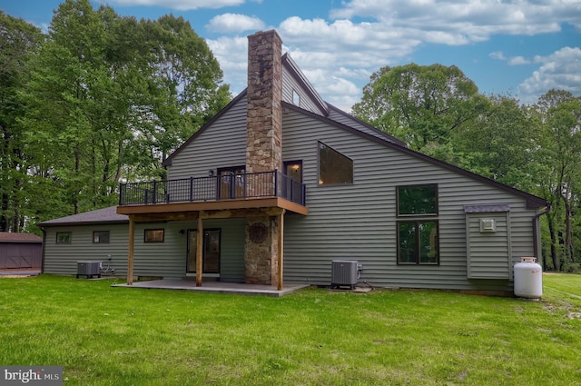 2655 Gap Newport Pike, West Grove, PA 19390 - rear view of house with central AC unit, a lawn, a chimney, and a patio