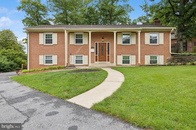 6309 Martins Ln, Lanham, MD 20706 - bi-level home featuring a chimney, a front yard, and brick siding