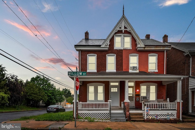 552 Willow St, Pottstown, PA 19464 - view of property featuring a chimney, covered porch, and brick siding