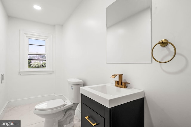 552 Willow St, Pottstown, PA 19464 - bathroom featuring toilet, vanity, baseboards, and marble finish flooring