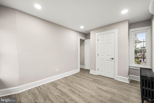 552 Willow St, Pottstown, PA 19464 - unfurnished bedroom with radiator heating unit, wood finished floors, baseboards, recessed lighting, and an AC wall unit