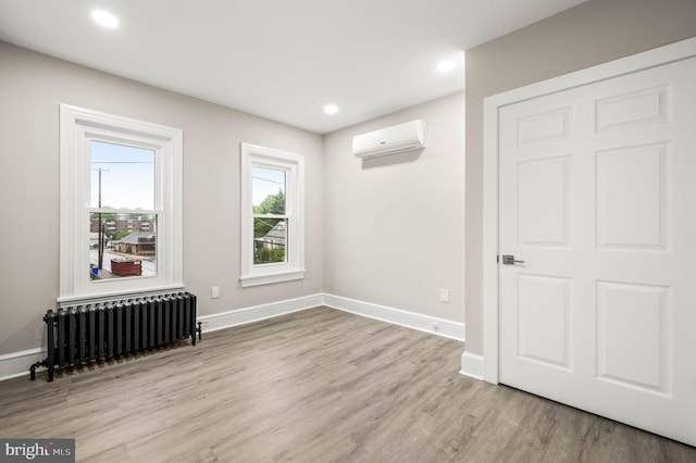 552 Willow St, Pottstown, PA 19464 - empty room featuring radiator, a wall mounted AC, wood finished floors, baseboards, and recessed lighting