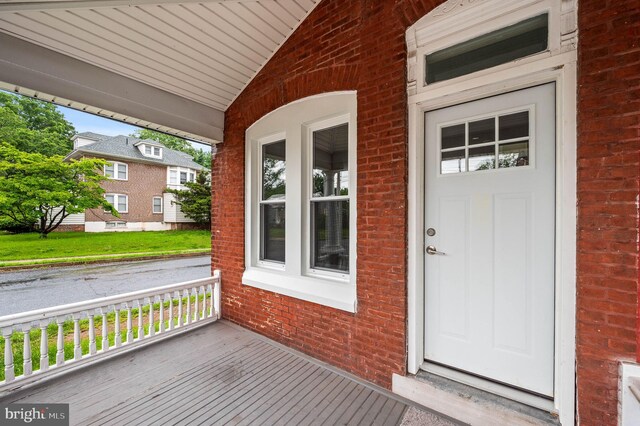 552 Willow St, Pottstown, PA 19464 - doorway to property featuring covered porch and brick siding