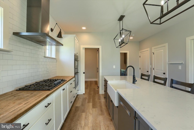 104 Lightfoot Ln, Dillsburg, PA 17019 - kitchen featuring ventilation hood, a sink, decorative backsplash, white cabinetry, and black gas cooktop