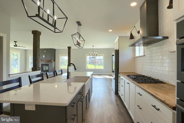 104 Lightfoot Ln, Dillsburg, PA 17019 - kitchen with wall chimney range hood, freestanding refrigerator, a sink, dark wood-type flooring, and decorative backsplash