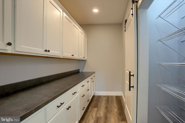 104 Lightfoot Ln, Dillsburg, PA 17019 - washroom featuring a barn door, dark wood-style floors, baseboards, and recessed lighting