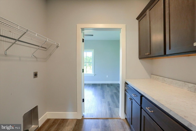 104 Lightfoot Ln, Dillsburg, PA 17019 - laundry area featuring dark wood-style floors, electric dryer hookup, baseboards, and cabinet space