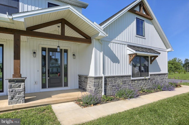 104 Lightfoot Ln, Dillsburg, PA 17019 - entrance to property featuring stone siding, covered porch, a standing seam roof, and metal roof
