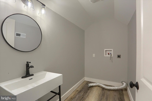 104 Lightfoot Ln, Dillsburg, PA 17019 - bathroom with a sink, wood finished floors, baseboards, and vaulted ceiling
