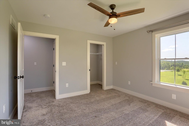 104 Lightfoot Ln, Dillsburg, PA 17019 - unfurnished bedroom featuring carpet flooring, baseboards, a ceiling fan, a walk in closet, and a closet