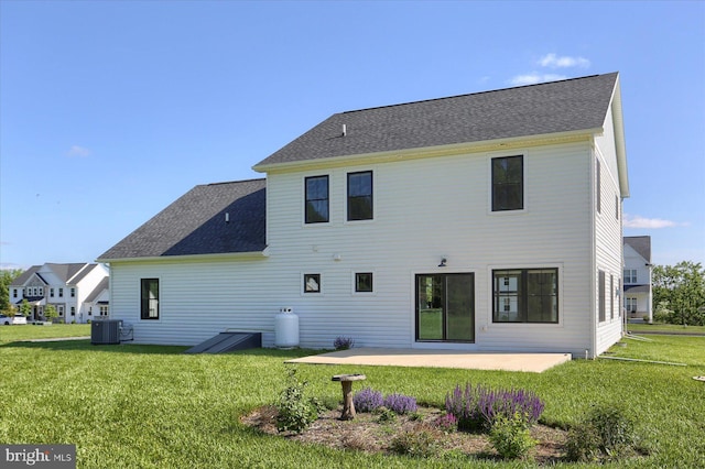104 Lightfoot Ln, Dillsburg, PA 17019 - rear view of property featuring central AC unit, a yard, a patio, and a shingled roof