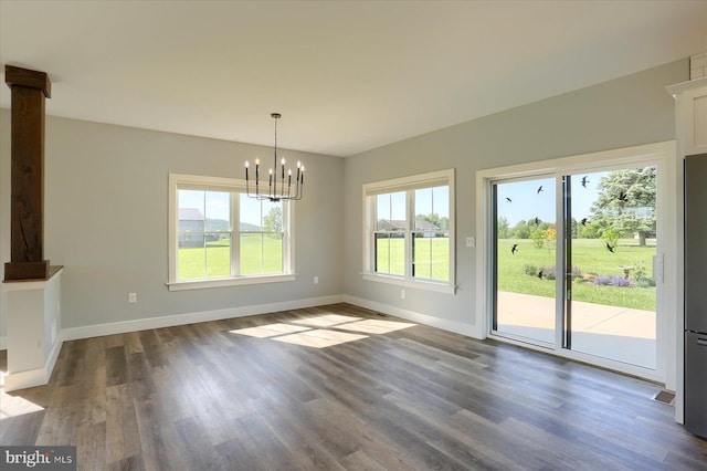104 Lightfoot Ln, Dillsburg, PA 17019 - unfurnished dining area featuring a chandelier, dark wood-type flooring, and baseboards