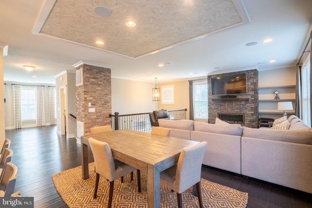 22270 Foggy Ridge Ter, Ashburn, VA 20148 - dining area featuring healthy amount of natural light, a stone fireplace, recessed lighting, ornamental molding, and dark wood-style floors