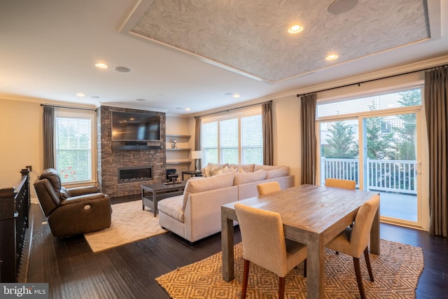 22270 Foggy Ridge Ter, Ashburn, VA 20148 - dining room with ornamental molding, healthy amount of natural light, a stone fireplace, dark wood-style floors, and recessed lighting