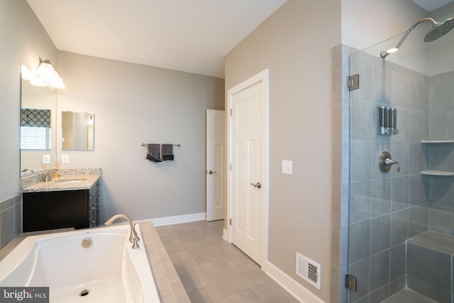 22270 Foggy Ridge Ter, Ashburn, VA 20148 - bathroom with a stall shower, a garden tub, vanity, and baseboards