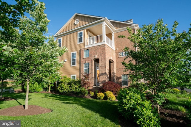 22270 Foggy Ridge Ter, Ashburn, VA 20148 - view of front of home featuring a front lawn, brick siding, and a balcony