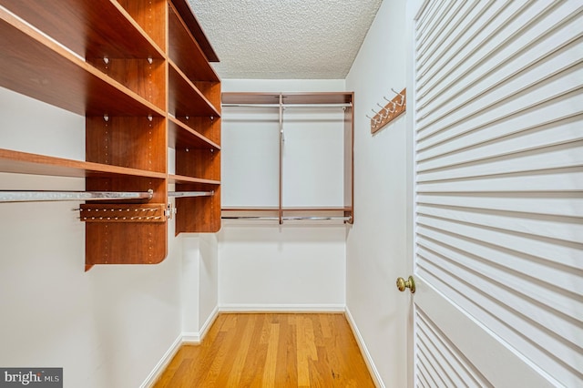 1101 S Arlington Ridge Rd Unit 216, Arlington, VA 22202 - walk in closet featuring wood finished floors