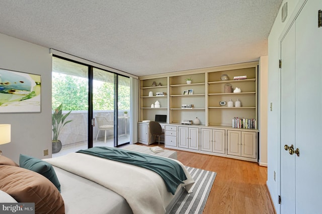 1101 S Arlington Ridge Rd Unit 216, Arlington, VA 22202 - bedroom with access to outside, light wood-style flooring, a textured ceiling, floor to ceiling windows, and an office area