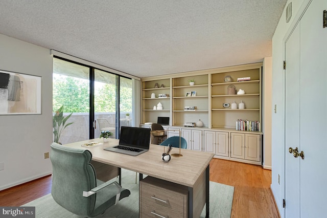 1101 S Arlington Ridge Rd Unit 216, Arlington, VA 22202 - office area featuring light wood-type flooring, a textured ceiling, and baseboards
