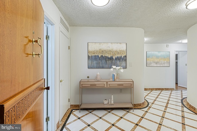 1101 S Arlington Ridge Rd Unit 216, Arlington, VA 22202 - corridor with baseboards, a textured ceiling, and inlaid floor details