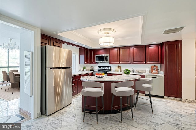 1101 S Arlington Ridge Rd Unit 216, Arlington, VA 22202 - kitchen with appliances with stainless steel finishes, reddish brown cabinets, a raised ceiling, light marble finish floors, and crown molding