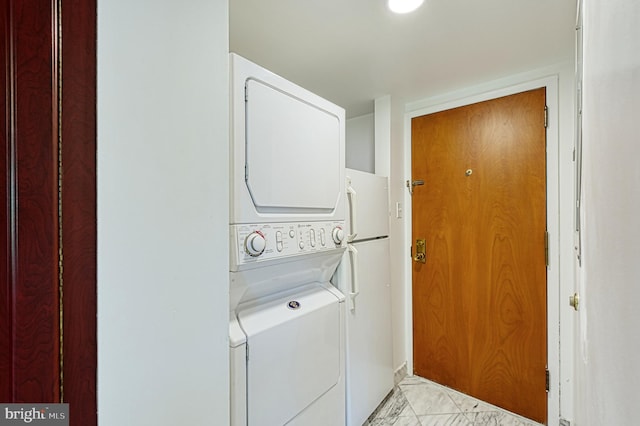 1101 S Arlington Ridge Rd Unit 216, Arlington, VA 22202 - washroom featuring stacked washer / dryer and light marble finish floors
