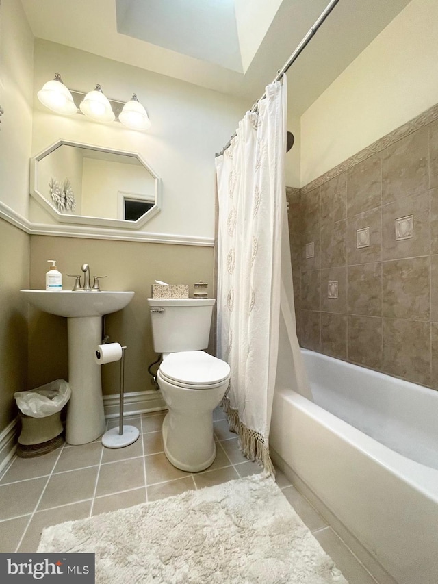 1820 S Dover St, Philadelphia, PA 19145 - bathroom with toilet, tile patterned flooring, shower / bath combo with shower curtain, and a sink