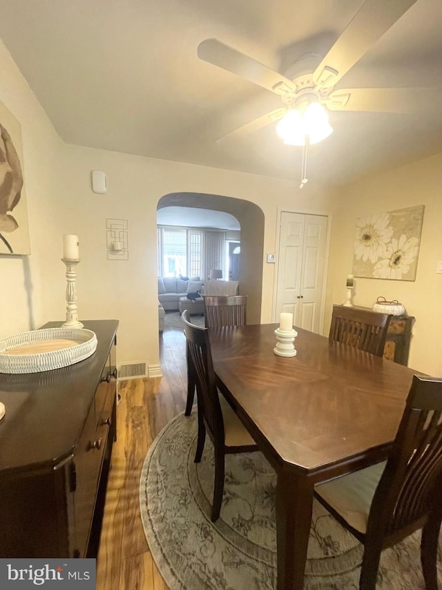 1820 S Dover St, Philadelphia, PA 19145 - dining area with arched walkways, wood finished floors, ceiling fan, and baseboards