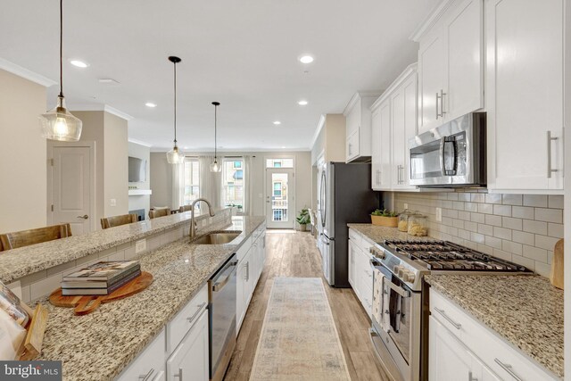 45210 Lettermore Sq, Sterling, VA 20166 - kitchen with appliances with stainless steel finishes, a sink, light wood-type flooring, crown molding, and white cabinetry