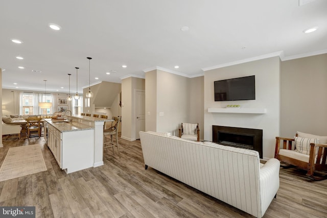 45210 Lettermore Sq, Sterling, VA 20166 - living area with a fireplace, recessed lighting, crown molding, light wood-type flooring, and baseboards