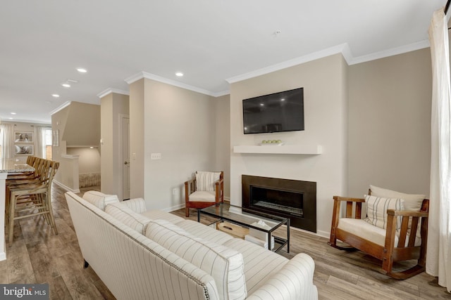 45210 Lettermore Sq, Sterling, VA 20166 - living area featuring ornamental molding, light wood-type flooring, baseboards, a fireplace, and recessed lighting