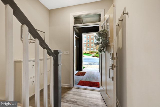 45210 Lettermore Sq, Sterling, VA 20166 - entryway featuring light wood-style flooring, stairway, and baseboards