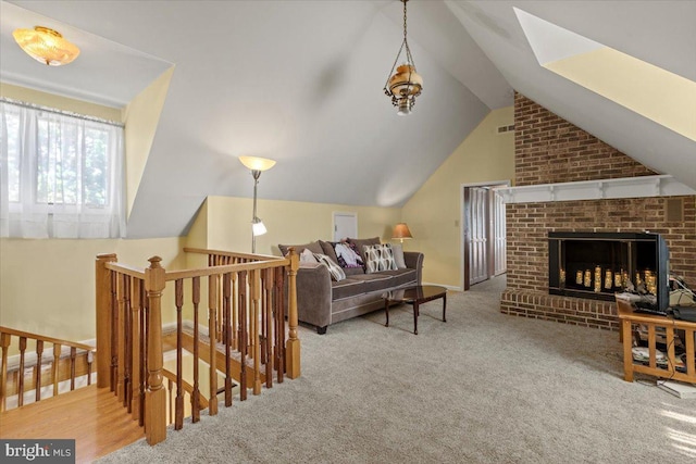 49716 Airedele Rd, Ridge, MD 20680 - living area featuring vaulted ceiling, carpet, and a fireplace