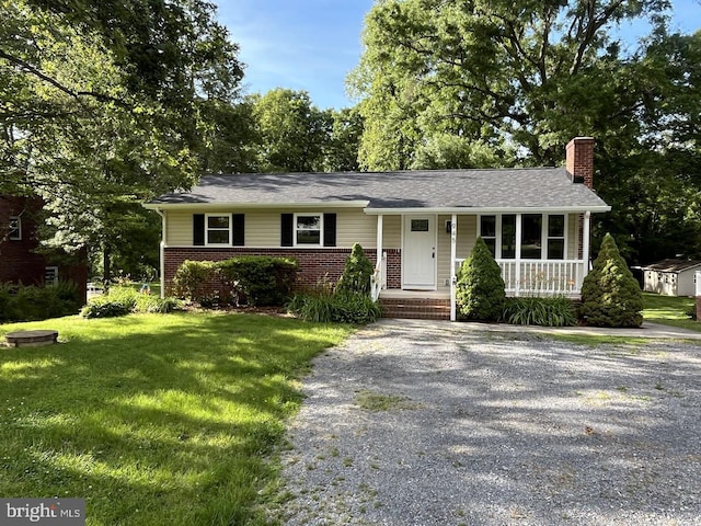 945 Ficklen Rd, Fredericksburg, VA 22405 - ranch-style house with a chimney, covered porch, brick siding, a front lawn, and driveway