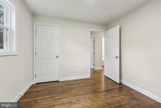 945 Ficklen Rd, Fredericksburg, VA 22405 - unfurnished bedroom with baseboards and dark wood-type flooring