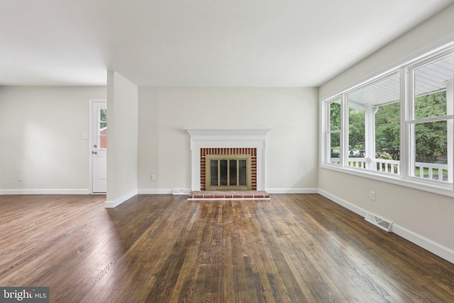 945 Ficklen Rd, Fredericksburg, VA 22405 - unfurnished living room featuring wood finished floors, baseboards, and a brick fireplace
