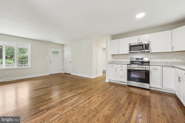 945 Ficklen Rd, Fredericksburg, VA 22405 - kitchen with appliances with stainless steel finishes, dark wood-style floors, white cabinets, baseboards, and recessed lighting