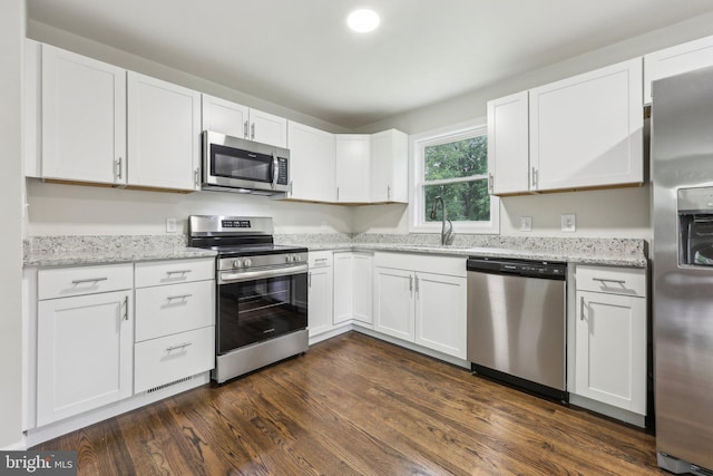 945 Ficklen Rd, Fredericksburg, VA 22405 - kitchen featuring stainless steel appliances, a sink, white cabinets, light stone counters, and dark wood-style flooring