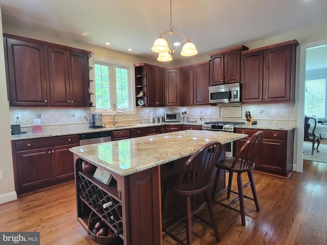 21785 Watson Rd, Leesburg, VA 20175 - kitchen with open shelves, stainless steel appliances, a sink, a center island, and a chandelier