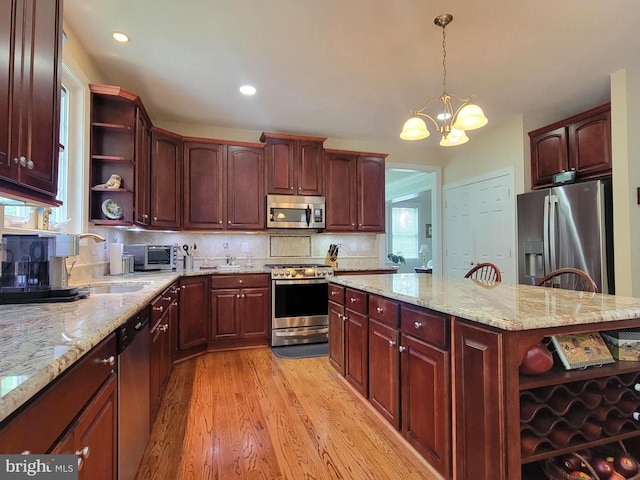 21785 Watson Rd, Leesburg, VA 20175 - kitchen with open shelves, stainless steel appliances, light wood-style flooring, a sink, and a chandelier