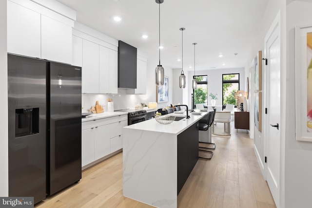 1208 M St NW Unit 52, Washington, DC 20005 - kitchen with stainless steel appliances, modern cabinets, a kitchen island with sink, white cabinetry, and a sink