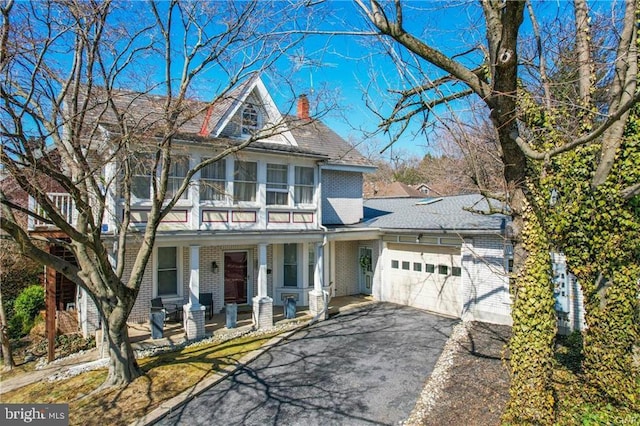 517 W Burke St, Easton, PA 18042 - traditional-style home with brick siding, an attached garage, a porch, driveway, and a chimney